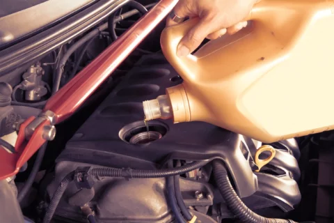 Adding new engine oil to car engine